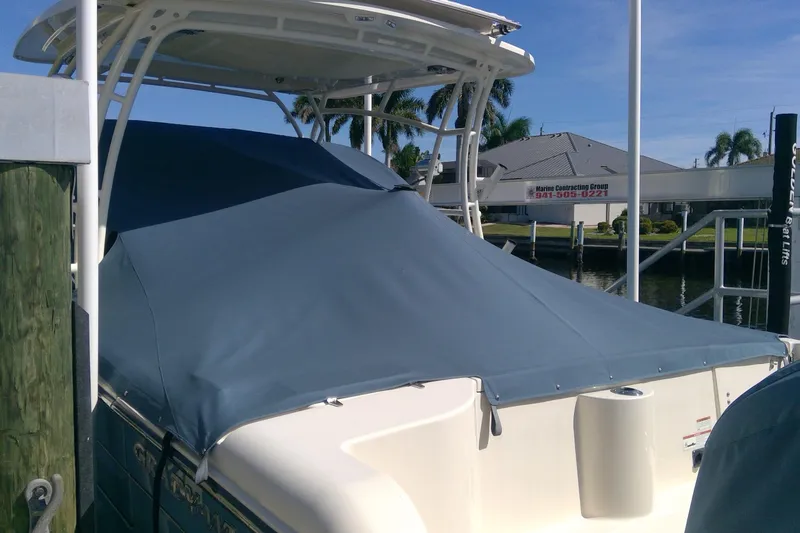 Slide: The Image of 2023 Grady-White Freedom 285 boat with protective cover at dockside. - 52