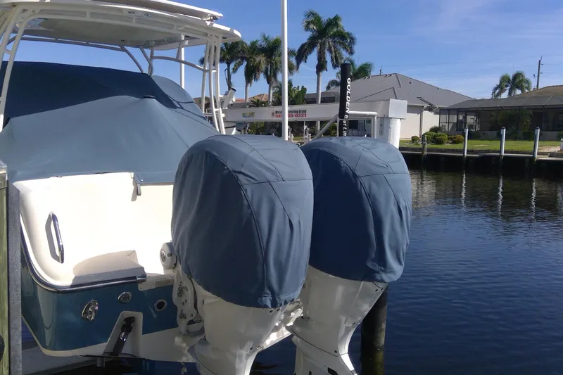 Slide: The Image of 2023 Grady-White Freedom 285 boat docked, covered engines, sunny day, waterfront view. - 53