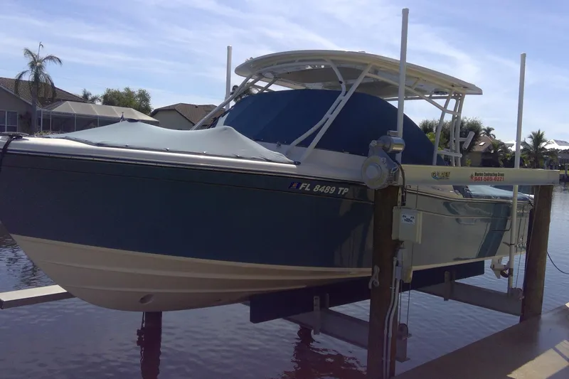 Slide: The Image of 2023 Grady-White Freedom 285 boat on lift by waterfront homes. - 54