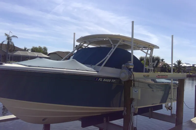 Slide: The Image of 2023 Grady-White Freedom 285 boat docked on a lift under a clear sky. - 55