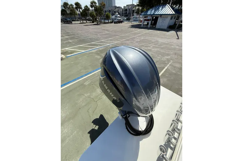 Slide: The Image of 2023 Parker 2320 Sport Cabin with Yamaha outboard in a sunny parking lot. - 24