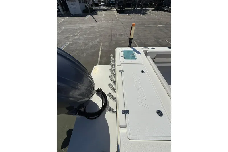 Slide: The Image of 2023 Parker 2320 Sport Cabin boat deck with engine and storage compartments. - 25