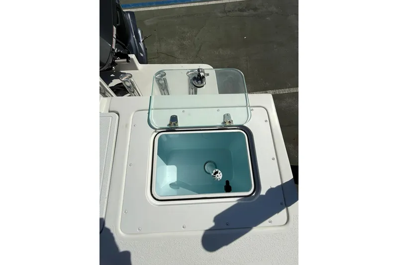 Slide: The Image of Livewell on 2023 Parker 2320 Sport Cabin boat, featuring a clear lid and clean design. - 32