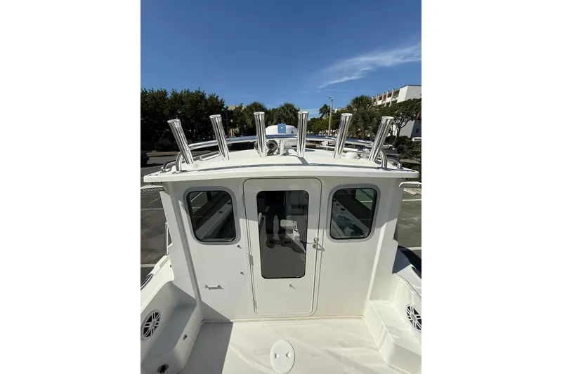 Slide: The Image of 2023 Parker 2320 Sport Cabin boat with rod holders, viewed from the deck. - 37