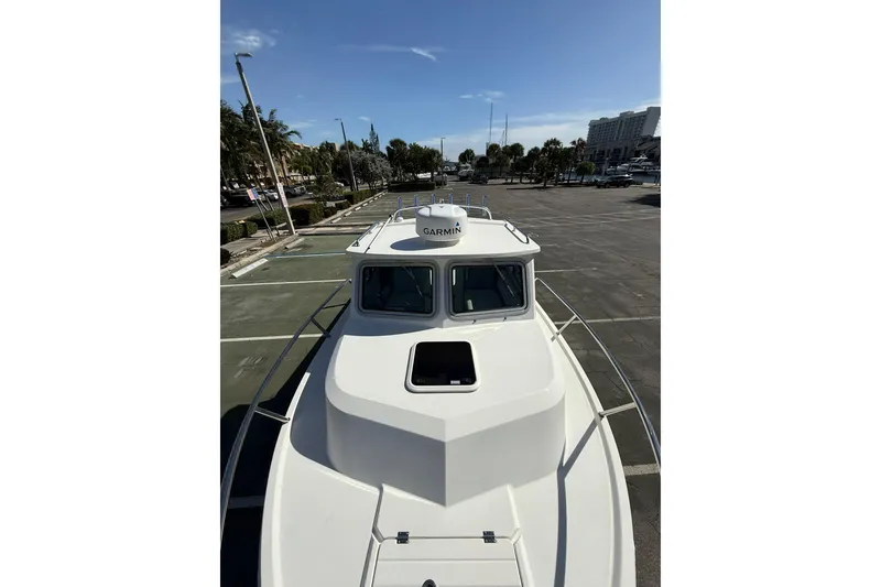 Slide: The Image of 2023 Parker 2320 Sport Cabin boat in parking lot, sunny day. - 42