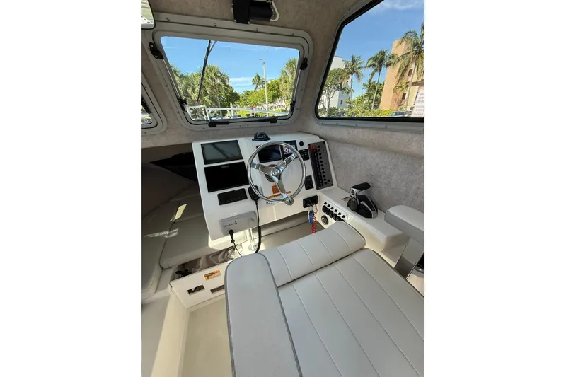 Slide: The Image of 2023 Parker 2320 Sport Cabin interior with steering wheel and control panel. - 54