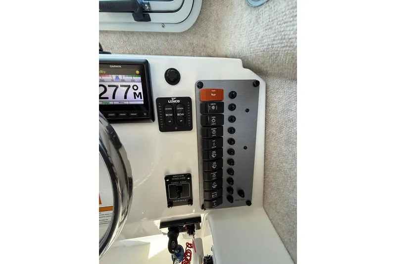 Slide: The Image of Control panel of 2023 Parker 2320 Sport Cabin boat with Garmin display and switches. - 60