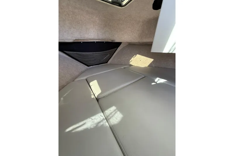 Slide: The Image of 2023 Parker 2320 Sport Cabin interior with cushioned seating and storage net. - 67