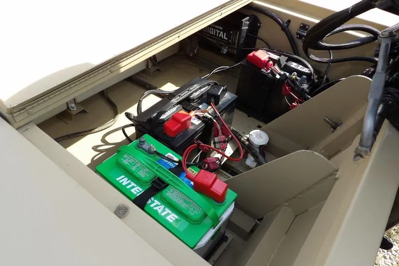 Slide: The Image of 2023 Crestliner 2070 Retriever SC boat battery compartment with wiring and components. - 27