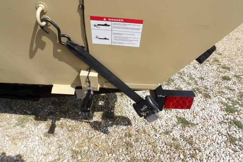 Slide: The Image of 2023 Crestliner 2070 Retriever SC trailer hitch with safety strap and warning label. - 32