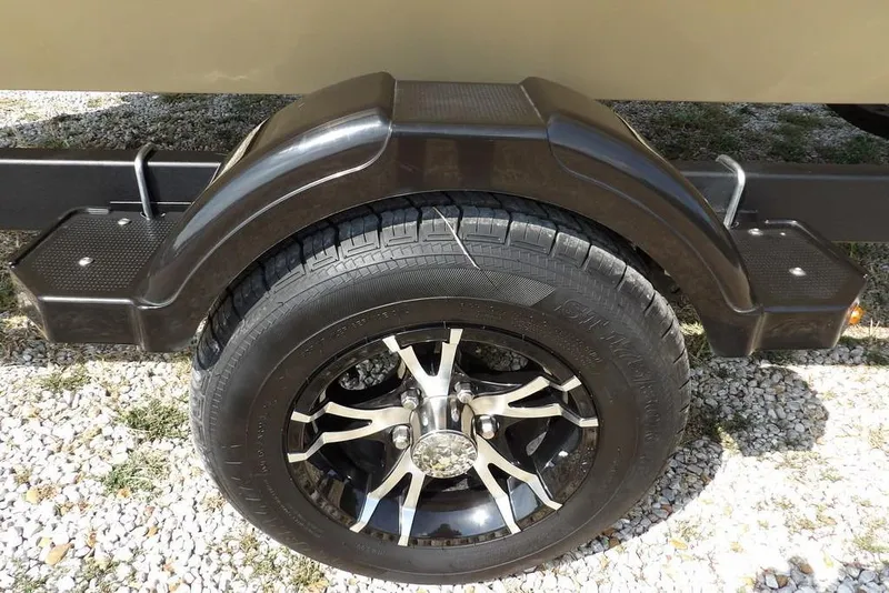 Slide: The Image of 2023 Crestliner 2070 Retriever SC trailer wheel and fender on gravel surface. - 34