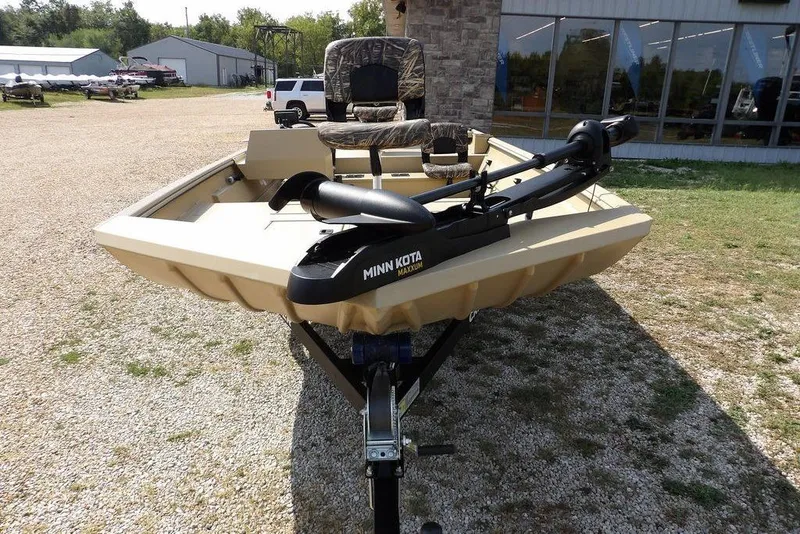 Slide: The Image of 2023 Crestliner 2070 Retriever SC boat with Minn Kota trolling motor, parked outdoors. - 38