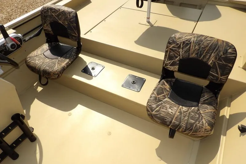 Slide: The Image of 2023 Crestliner 2070 Retriever SC boat interior with camo seats and steering console. - 9
