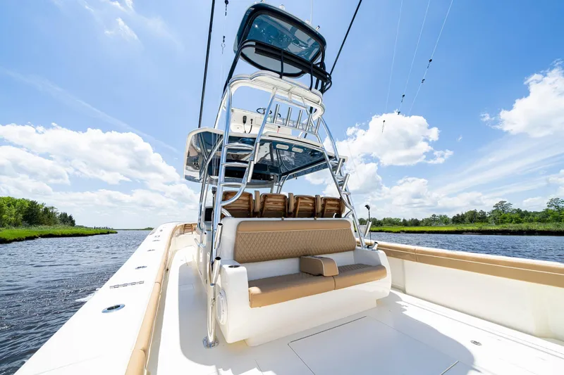 Slide: The Image of 2023 Valhalla Boatworks V-46 helm with advanced navigation system on a scenic waterway. - 13