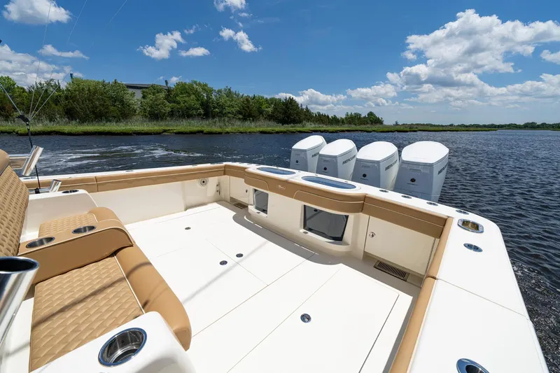 Slide: The Image of 2023 Valhalla Boatworks V-46 luxury deck with seating, under a bright blue sky. - 15