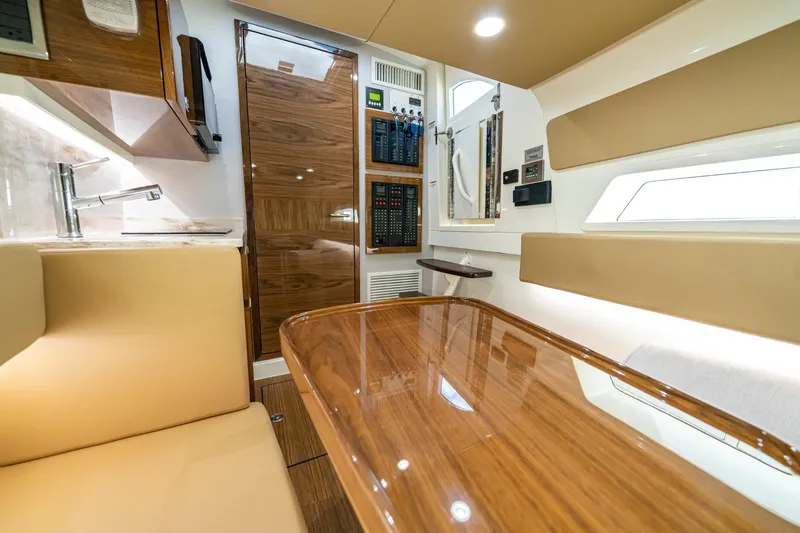 Slide: The Image of 2023 Valhalla Boatworks V-46 bow storage compartment with open hatch, scenic water view. - 19