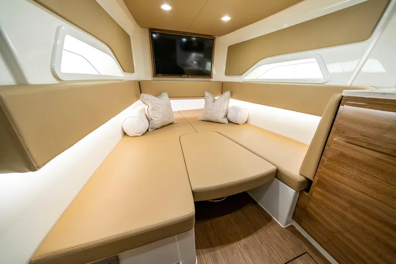 Slide: The Image of 2023 Valhalla Boatworks V-46 helm view on water, featuring sleek design and American flag. - 21