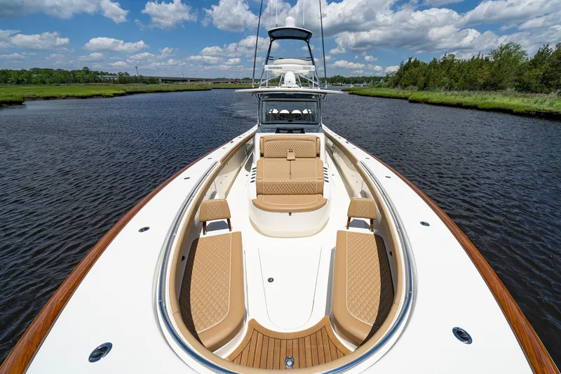Slide: The Image of 2023 Valhalla Boatworks V-46 on water, sunny day, luxurious seating, scenic view. - 8