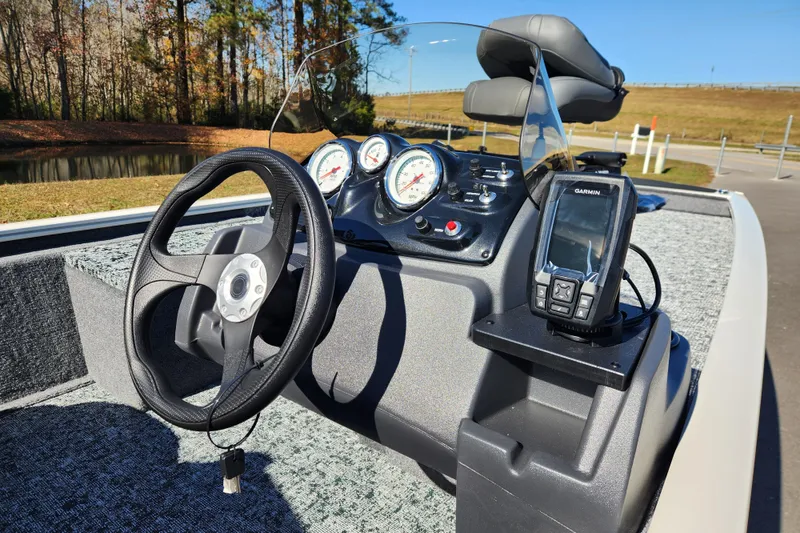 Slide: The Image of 2026 Tracker Pro 170 boat dashboard with steering wheel and Garmin GPS system. - 10