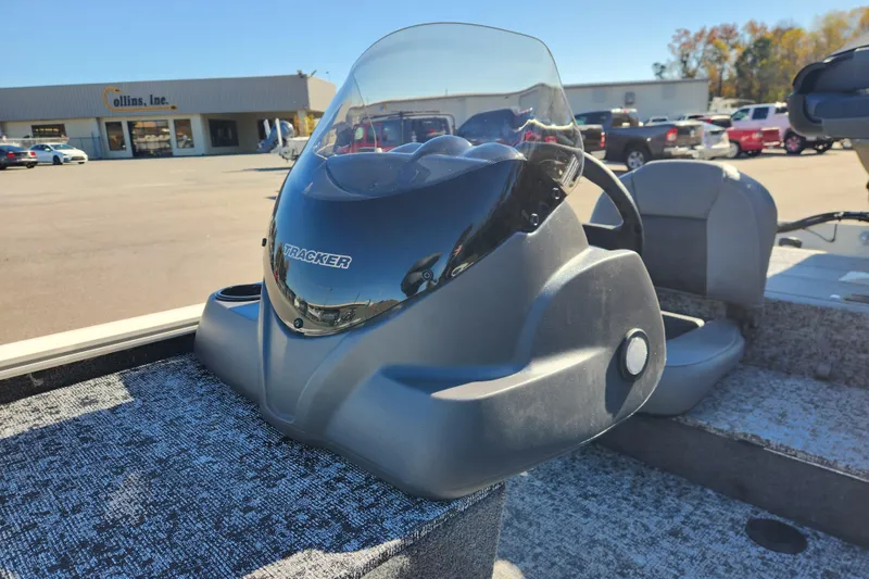 Slide: The Image of 2026 Tracker Pro 170 boat console with windshield in a dealership lot. - 11
