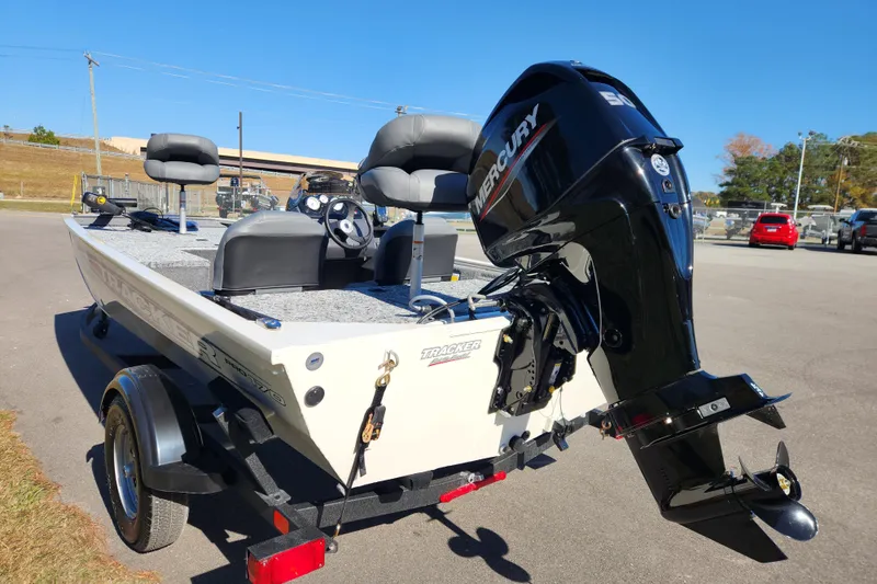 Slide: The Image of 2026 Tracker Pro 170 boat with Mercury engine, parked on a trailer in a sunny outdoor setting. - 3