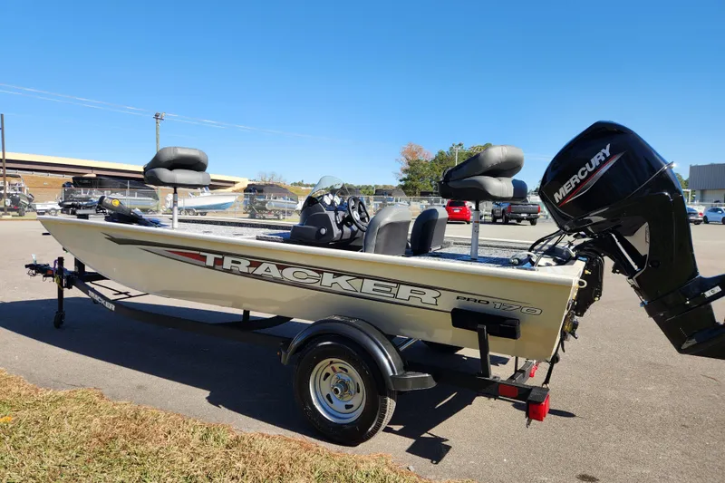 Slide: The Image of 2026 Tracker Pro 170 boat with Mercury engine on trailer, parked outdoors. - 4