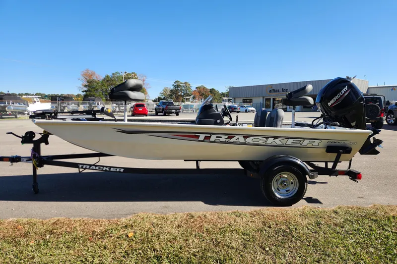 Slide: The Image of 2026 Tracker Pro 170 boat on trailer, parked outdoors under clear blue sky. - 5