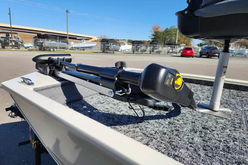 Slide: The Image of 2026 Tracker Pro 170 boat with trolling motor on deck, parked outdoors. - 7