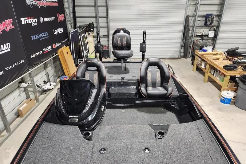 Slide: The Image of 2019 Nitro Z20 Pro boat in a garage, featuring three seats and a sleek design. - 10