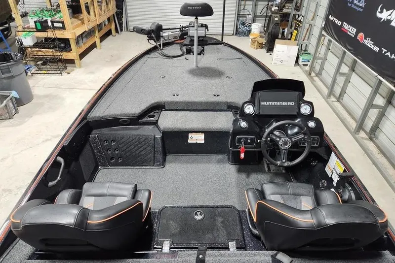 Slide: The Image of 2019 Nitro Z20 Pro boat interior with steering console and seating in a garage setting. - 6