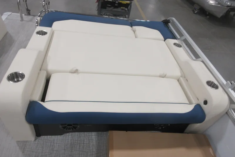 Slide: The Image of 2026 Avalon LSZ 2585 Entertainer Triple toon boat seating with cup holders and blue accents. - 20