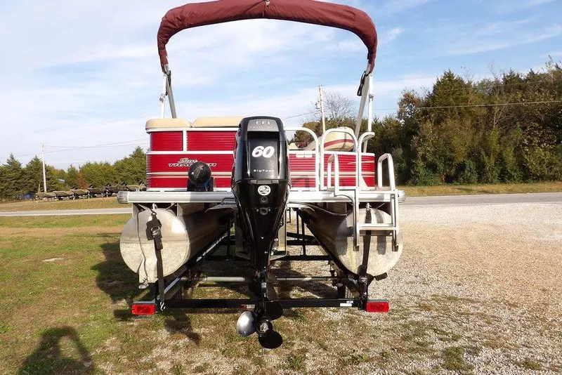 Slide: The Image of 2012 Sun Tracker Party Barge 22 DLX pontoon boat with outboard motor, parked on grass. - 10