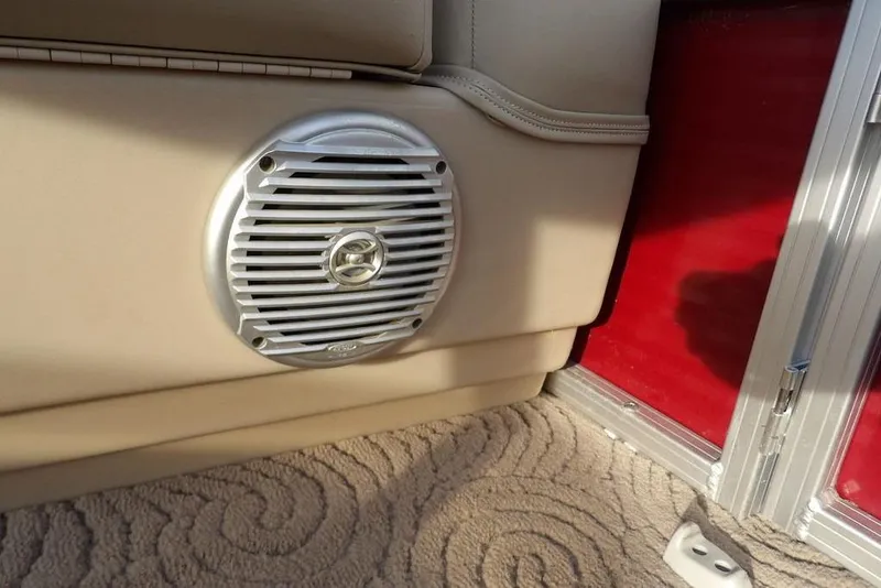 Slide: The Image of Speaker on 2012 Sun Tracker Party Barge 22 DLX with beige interior and red panel. - 13