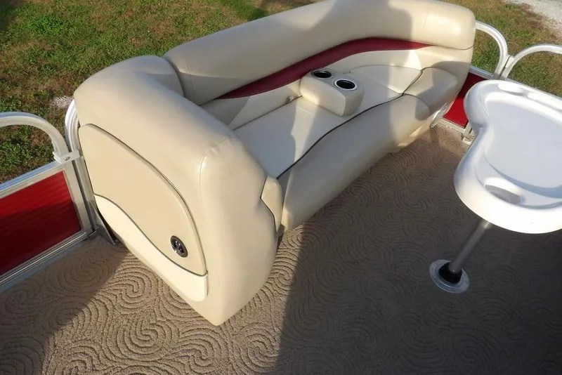 Slide: The Image of 2012 Sun Tracker Party Barge 22 DLX interior with beige seating and table. - 16