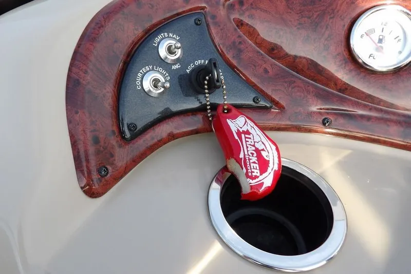 Slide: The Image of Control panel of 2012 Sun Tracker Party Barge 22 DLX with keychain and fuel gauge. - 19