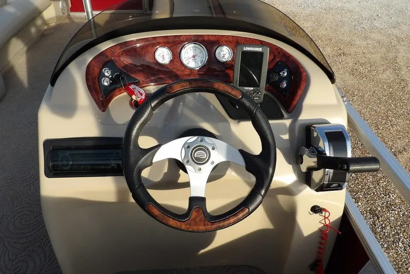 Slide: The Image of 2012 Sun Tracker Party Barge 22 DLX dashboard with steering wheel and controls. - 20