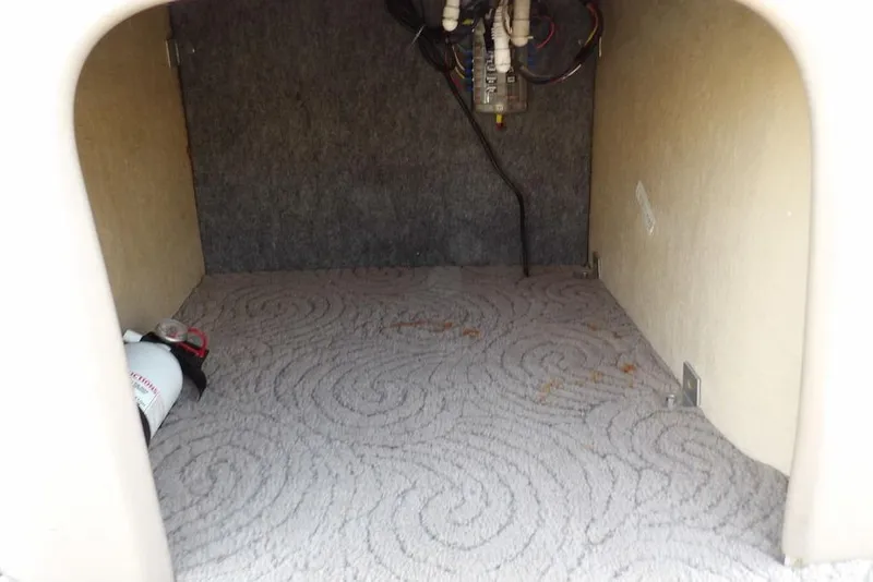 Slide: The Image of Interior storage compartment of 2012 Sun Tracker Party Barge 22 DLX with fire extinguisher. - 21