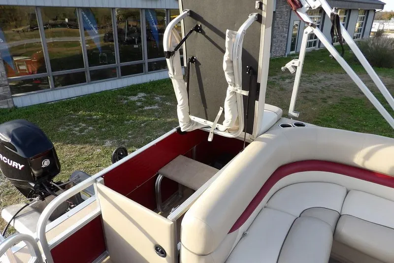 Slide: The Image of 2012 Sun Tracker Party Barge 22 DLX interior with seating and Mercury outboard motor. - 26