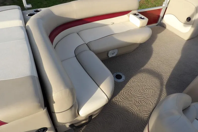Slide: The Image of 2012 Sun Tracker Party Barge 22 DLX interior with beige seating and carpet. - 28
