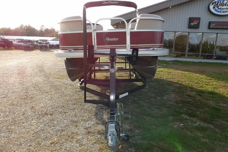 Slide: The Image of 2012 Sun Tracker Party Barge 22 DLX pontoon boat on trailer, outdoor dealership setting. - 3