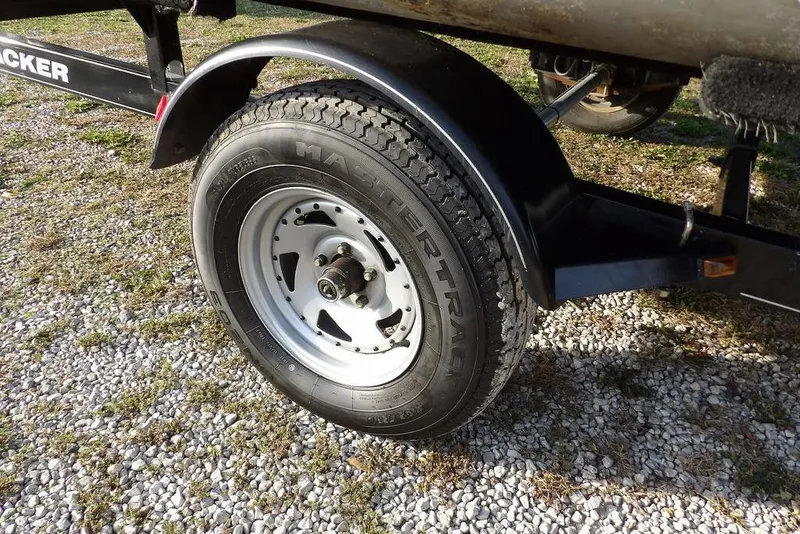Slide: The Image of Trailer wheel of 2012 Sun Tracker Party Barge 22 DLX on gravel surface. - 35