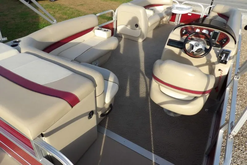 Slide: The Image of 2012 Sun Tracker Party Barge 22 DLX interior with beige and red seating, steering console. - 36