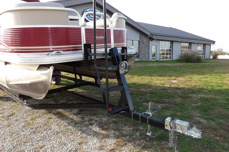 Slide: The Image of 2012 Sun Tracker Party Barge 22 DLX pontoon boat on trailer near a building. - 38