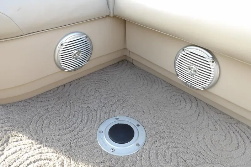 Slide: The Image of 2012 Sun Tracker Party Barge 22 DLX interior with speakers and patterned carpet. - 39