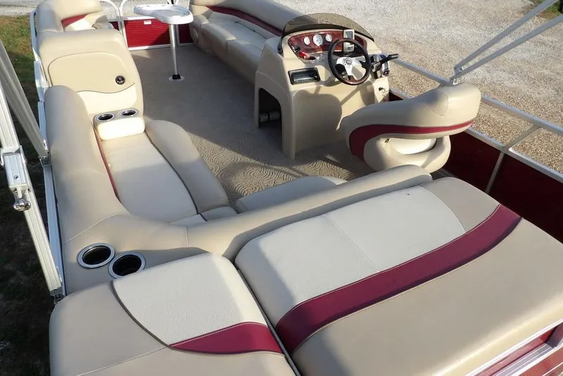 Slide: The Image of 2012 Sun Tracker Party Barge 22 DLX interior with beige and maroon seating, steering console. - 40