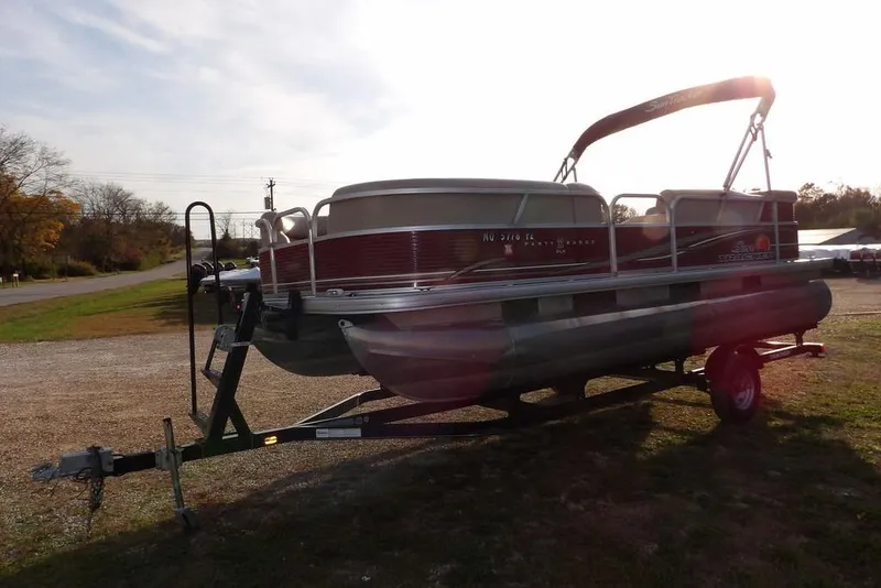 Slide: The Image of 2012 Sun Tracker Party Barge 22 DLX pontoon boat on trailer, parked outdoors. - 5