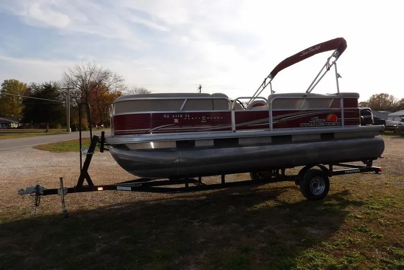 Slide: The Image of 2012 Sun Tracker Party Barge 22 DLX pontoon boat on trailer, parked outdoors. - 7