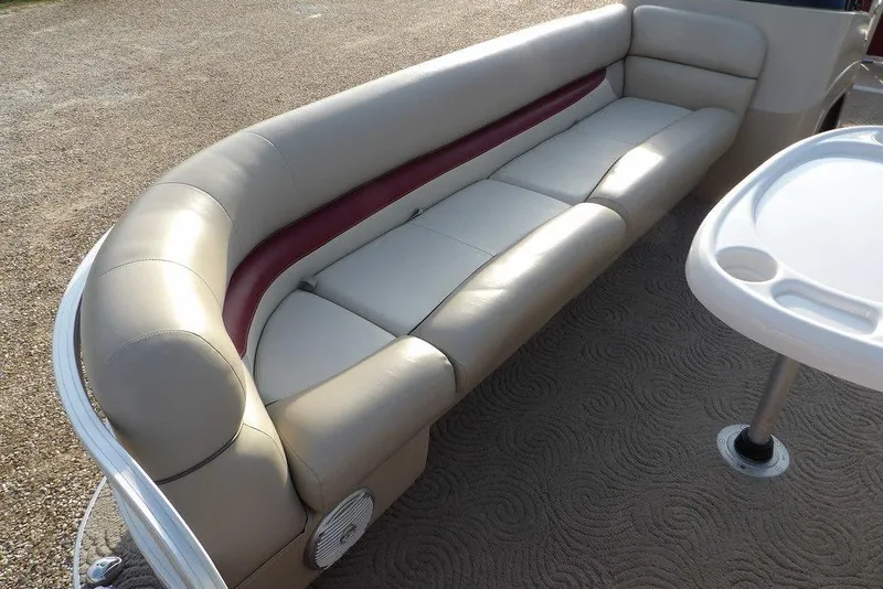 Slide: The Image of 2012 Sun Tracker Party Barge 22 DLX interior with beige seating and table. - 8