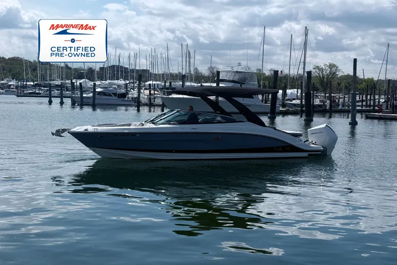 Slide: The Image of A 2024 Sea Ray SLX 260 Outboard is on the water, surrounded by yachts and masts. - 0