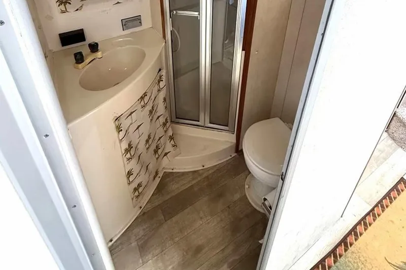 Slide: The Image of Bathroom interior of 1990 Silverton 34 Convertible boat with shower and toilet. - 10